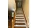 Wooden staircase with wooden railing leading to the upper level at 936 Elbridge Dr, Raleigh, NC 27603