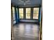 Sunroom with wood flooring and multiple windows offering backyard view at 936 Elbridge Dr, Raleigh, NC 27603