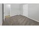 Well-lit bedroom with neutral carpeting and an adjacent closet at 112 Bradsher Rd, Roxboro, NC 27574