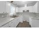 Kitchen with white cabinets and marble countertops at 112 Bradsher Rd, Roxboro, NC 27574