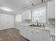 Bright kitchen featuring white cabinets, stainless steel sink, and modern countertops at 112 Bradsher Rd, Roxboro, NC 27574