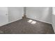 Bright bedroom with neutral carpeting and walls at 112 Bradsher Rd, Roxboro, NC 27574