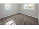Spacious bedroom with neutral carpeting and two windows at 112 Bradsher Rd, Roxboro, NC 27574