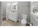 Updated bathroom features a vanity with white cabinets, a toilet, and hexagon tile floor at 112 Bradsher Rd, Roxboro, NC 27574
