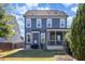 Two-story house with gray siding, screened porch, and backyard at 228 Vintage Point Ln, Wendell, NC 27591