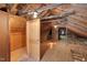 Unfinished attic space with exposed beams and storage areas at 2445 Pineway Dr, Burlington, NC 27215