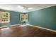 Charming bedroom with hardwood floors and teal walls at 2445 Pineway Dr, Burlington, NC 27215