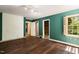 Unfinished bedroom with hardwood floors and teal walls at 2445 Pineway Dr, Burlington, NC 27215