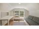 Small attic bedroom with a built-in desk and window at 2445 Pineway Dr, Burlington, NC 27215