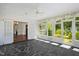 Sunroom features slate tile flooring, built-in benches, and abundant natural light at 2445 Pineway Dr, Burlington, NC 27215