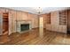 Living room with hardwood floors, stone fireplace, and built-in shelving at 2445 Pineway Dr, Burlington, NC 27215
