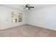 Carpeted bedroom with neutral walls and large windows at 4901 Harwood Ct, Durham, NC 27713