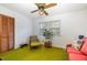 Bedroom with green carpeting, a red couch, and wood chair at 1148 Sturdivant Dr, Cary, NC 27511