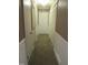 Long hallway with carpet, doors to rooms, and closets at 812 Siler City Glendon Rd, Siler City, NC 27344