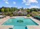 Community pool with lap lanes and surrounding clubhouse at 9432 Palm Bay Cir, Raleigh, NC 27617