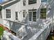 Gray deck and stairs leading to a house with multiple doors and windows at 9432 Palm Bay Cir, Raleigh, NC 27617