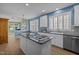 Kitchen with island, white cabinets, and stainless steel appliances at 9432 Palm Bay Cir, Raleigh, NC 27617