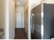 Hallway with view into kitchen and stainless steel refrigerator at 2326 Gathering Square Ct # 322, Fuquay Varina, NC 27526