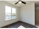 Bright bedroom with large window, hardwood floors and ceiling fan at 2326 Gathering Sq Ct, Fuquay Varina, NC 27526