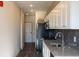 Long hallway with dark hardwood floors leading to kitchen and other rooms at 2326 Gathering Sq Ct, Fuquay Varina, NC 27526