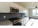 Modern kitchen with stainless steel appliances and granite countertops at 2326 Gathering Sq Ct, Fuquay Varina, NC 27526