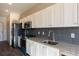 Modern kitchen with stainless steel appliances and granite countertops at 2326 Gathering Sq Ct, Fuquay Varina, NC 27526