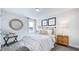 Serene bedroom with a sunburst mirror and neutral decor at 2620 Stonington Dr, Cary, NC 27523