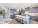 Island kitchen with white quartz countertops and gray cabinets at 2620 Stonington Dr, Cary, NC 27523