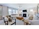 Relaxing living room with a fireplace, large windows, and comfortable seating at 2620 Stonington Dr, Cary, NC 27523