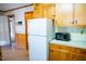 Bright kitchen with wood cabinets, microwave, and refrigerator at 513 Clayton Ave, Roxboro, NC 27573