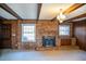 Living room with brick fireplace and wood paneling at 513 Clayton Ave, Roxboro, NC 27573