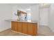 View of kitchen with wood cabinets, white appliances, and access to dining area at 6702 Twin Tree Ct, Raleigh, NC 27613