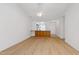 Open living room with hardwood floors and kitchen bar at 6702 Twin Tree Ct, Raleigh, NC 27613