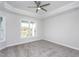 Bright bedroom with carpeting, large window, and ceiling fan at 1230 Linkwood, Homesite 44, Fuquay Varina, NC 27526