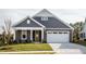 Two-story house with yellow front door, white garage, and manicured lawn at 1230 Linkwood, Homesite 44, Fuquay Varina, NC 27526
