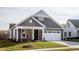 Gray-toned two-story house with white garage door and landscaped lawn at 1230 Linkwood, Homesite 44, Fuquay Varina, NC 27526