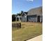 Gray house exterior with landscaping and black fence at 1230 Linkwood, Homesite 44, Fuquay Varina, NC 27526