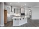 Modern kitchen with gray cabinets, quartz countertops, and stainless steel appliances at 1230 Linkwood, Homesite 44, Fuquay Varina, NC 27526