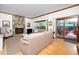 Spacious living room with stone fireplace, large windows, and hardwood floors at 403 Rutherglen Dr, Cary, NC 27511