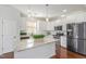 Kitchen with white cabinets, granite island and stainless steel appliances at 517 Birchrun Dr, Durham, NC 27712