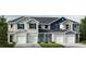 Three-unit townhome building with attached garages and modern exterior finishes at 1046 Mountain Crown St, Durham, NC 27703