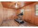 Room with wood paneling, treadmill, and dark flooring at 435 Tant Rd, Zebulon, NC 27597