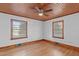 Bright bedroom with hardwood floors, wood ceiling, and two windows at 435 Tant Rd, Zebulon, NC 27597