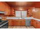 Kitchen with wood cabinets, stainless steel appliances and a large sink at 435 Tant Rd, Zebulon, NC 27597