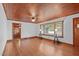Living room with hardwood floors, wood ceiling, and large window at 435 Tant Rd, Zebulon, NC 27597