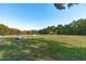 Large green pasture with pond and outbuildings at 435 Tant Rd, Zebulon, NC 27597