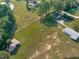 Aerial view of property with pond, home and outbuildings at 435 Tant Rd, Zebulon, NC 27597
