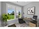 Bright home office with a large window and modern glass desk at 23 Eagle Crest Ct # Holly English Country, Lillington, NC 27546