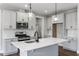 Modern kitchen with gray cabinets, quartz counters, and island at 23 Eagle Crest Ct # Holly English Country, Lillington, NC 27546