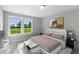 Bright bedroom with large windows and a comfortable bed at 23 Eagle Crest Ct # Holly English Country, Lillington, NC 27546